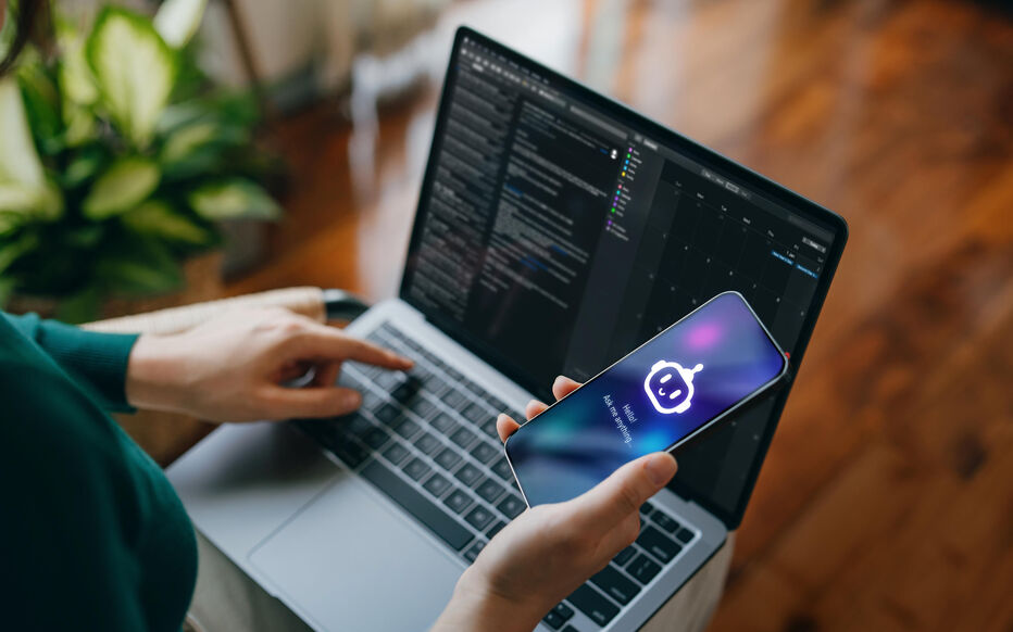 Asian woman using  AI chatbot virtual assistance app on smartphone to assist her while working on laptop. Using AI technology while working at home. Online robot system. Concept of VR and AR technologies. People, AI, innovation and technology